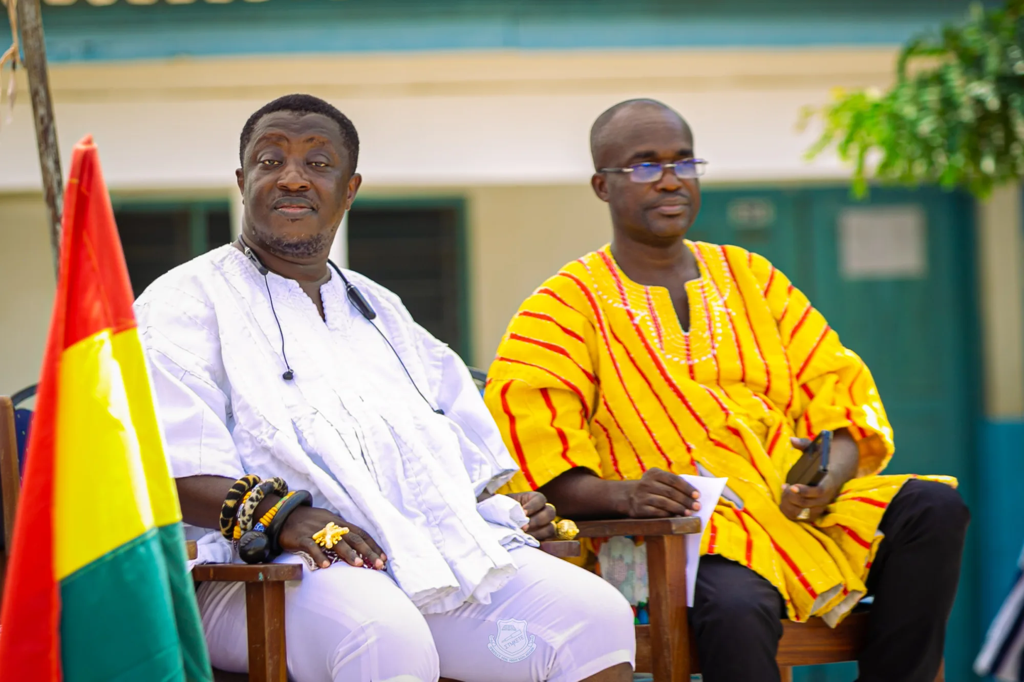 Older community dignitaries seated together at a school celebration